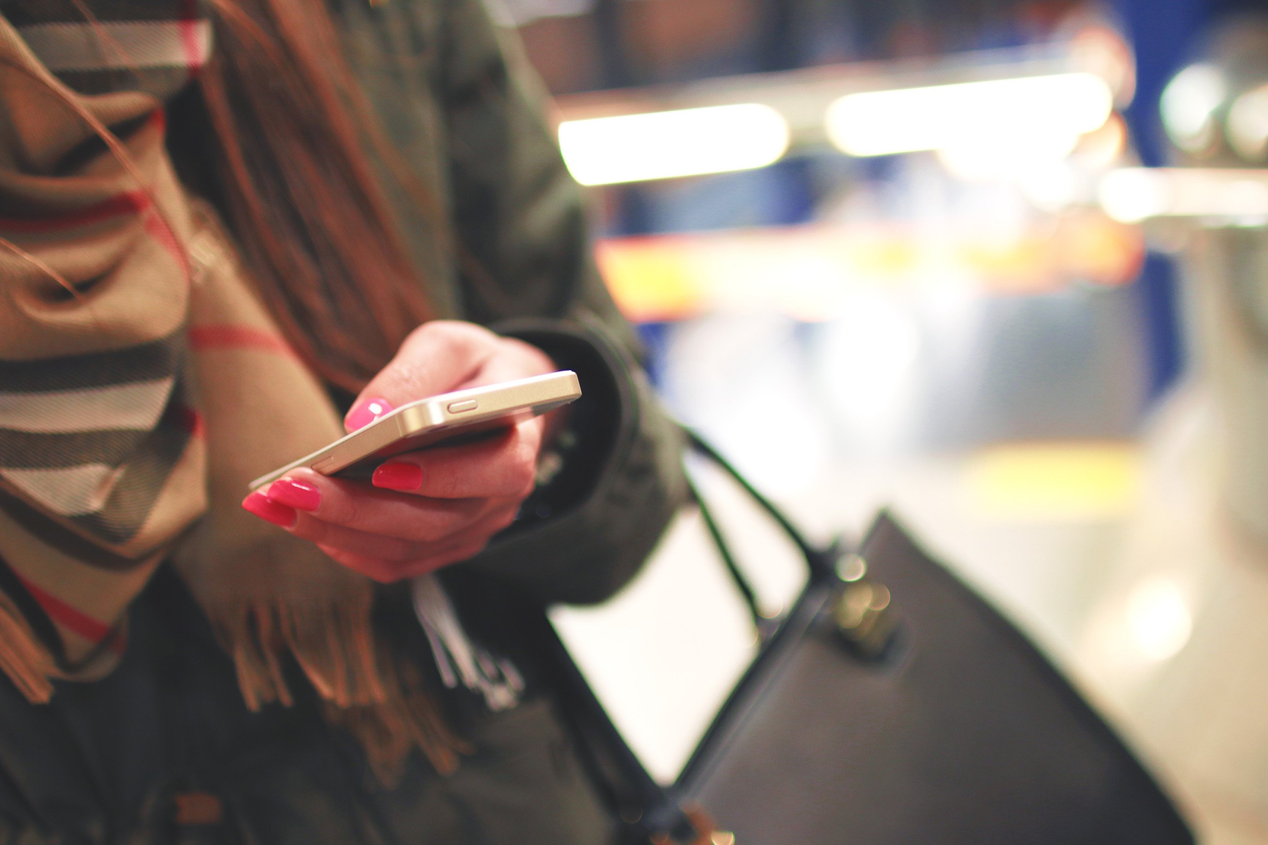 woman texting with bag and scarf